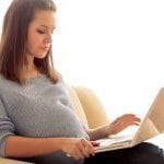 pregnant female with laptop.