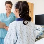 Nurse Writing Notes With Patient In Ultrasound Room
